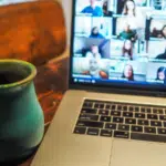 A laptop with people on a virtual conference.