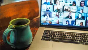 A laptop with people on a virtual conference.