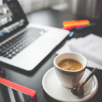 A woman is sitting at a desk with a notebook.