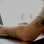 A man working on a laptop seeking sponsorships.