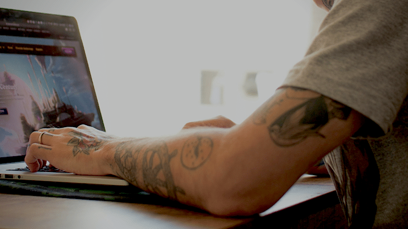 A man working on a laptop seeking sponsorships.