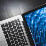 A laptop with a blue screen is sitting on a table, showcasing its content pillars for branding.