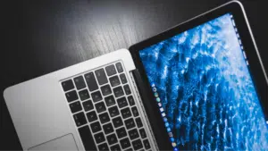 A laptop with a blue screen is sitting on a table, showcasing its content pillars for branding.