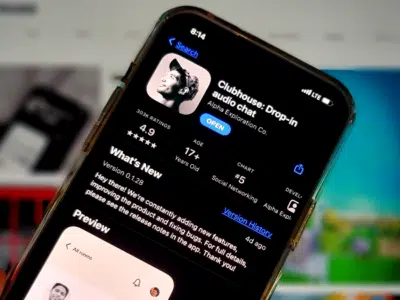 A person is holding a Clubhouse app on their phone.