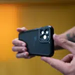 A person showcasing a black iPhone 11 Pro case in a YouTube Shorts video.