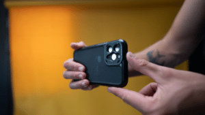 A person showcasing a black iPhone 11 Pro case in a YouTube Shorts video.