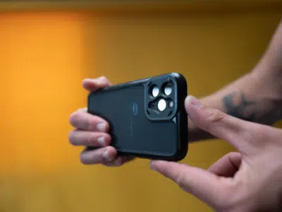 A person showcasing a black iPhone 11 Pro case in a YouTube Shorts video.