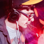 A man wearing headphones at a party, in sync with the placements.