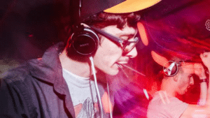 A man wearing headphones at a party, in sync with the placements.
