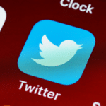 Twitter logos are displayed on a smartphone.