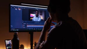 A man is watching a video on a computer screen, checking the content ID.