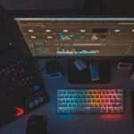 A desk with management tools including a laptop, keyboard and monitor.