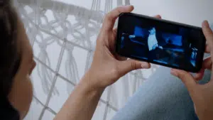 A woman is recording a video on her phone for Youtube promotion.