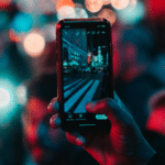 A person capturing a crowd at night using Instagram's algorithm.