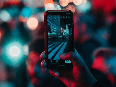 A person capturing a crowd at night using Instagram's algorithm.