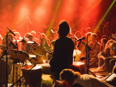 A group of people performing on stage at a concert, attracting crowds as marketing drivers.