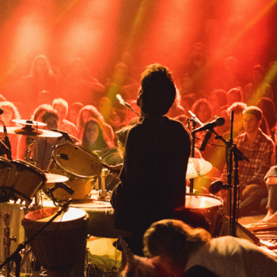 A group of people performing on stage at a concert, attracting crowds as marketing drivers.