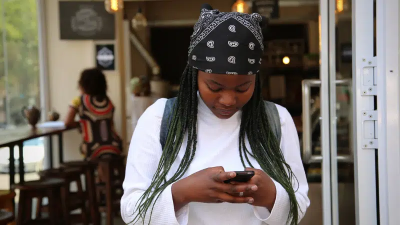 woman texting in a coffee shop