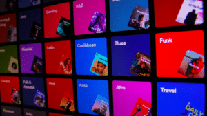 An image of a colorful screen displaying various types of music, reminiscent of Spotify.