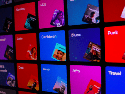 An image of a colorful screen displaying various types of music, reminiscent of Spotify.