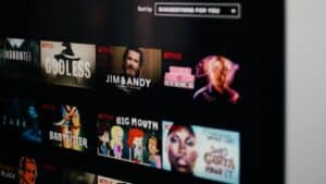 A tv screen showing a synced variety of movies on Netflix.