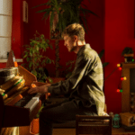 Piano, red walls.