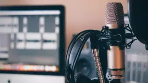 A microphone is positioned in front of a computer.