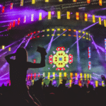 A crowd of people at a concert in the Metaverse with colorful lights.