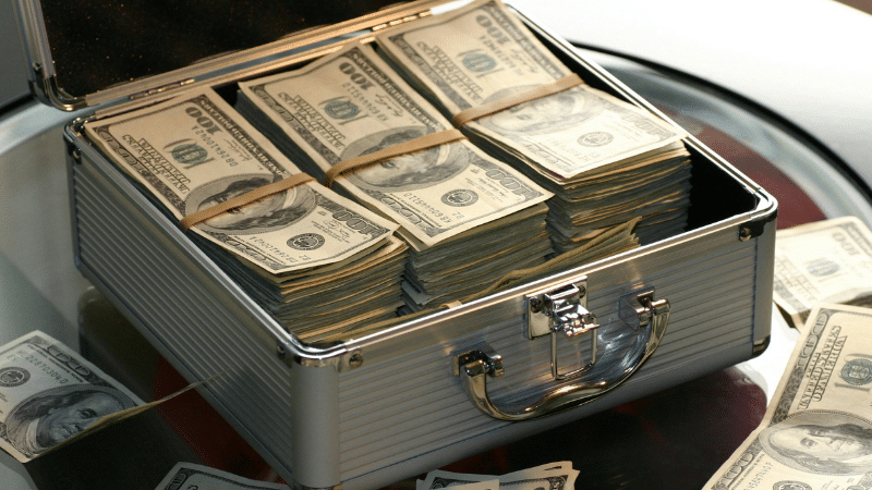 A briefcase full of funding on a table.