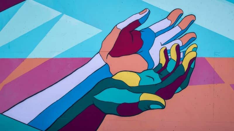 A vibrant mural illustrating the importance of mental health through interconnected hands.