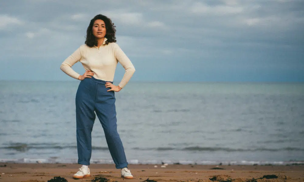 A woman standing on the beach.