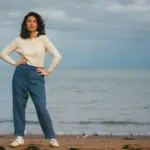 A woman standing on the beach.