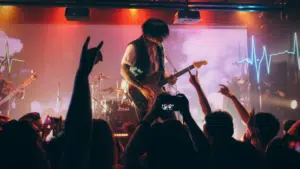 A man playing guitar on stage.