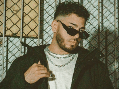 A man conducting case studies while standing next to a fence.
