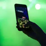 A person is capturing a concert moment with their cell phone for an Instagram Reels video.