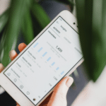 A person holding a smartphone with an Instagram plant.