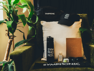 An eco-friendly chair with a bottle of water, a hat, and a plant.