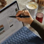 A woman using a Surface laptop for email marketing.