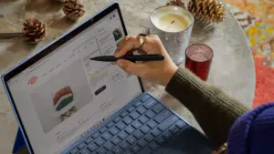 A woman using a Surface laptop for email marketing.