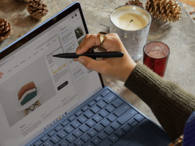 A woman using a Surface laptop for email marketing.