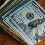 A stack of dollar bills - Ways musicians can make money.
