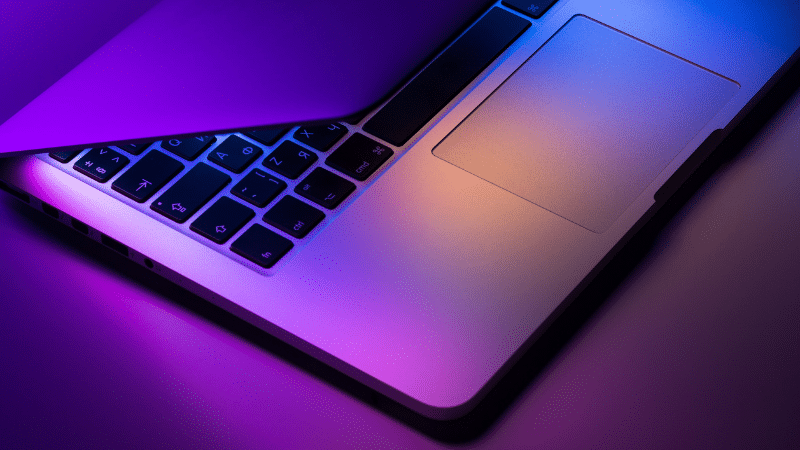 A laptop with purple and blue lights on it designed for social media enthusiasts.