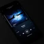 A smartphone screen displays a music player app with a dark-themed interface, featuring the song "Meridian" by ODESZA. The album art shows a hand reaching towards a blue light, perfectly framed on the label page.