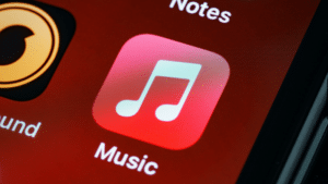 A cell phone with the Apple Music icon on it.