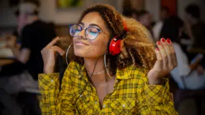 A young woman with headphones in a women-owned restaurant.