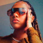 A Neo Soul woman wearing sunglasses.