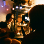 A person capturing an acoustic guitarist's performance for Instagram Reels.