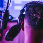 A person wearing headphones in a Tidal recording studio.