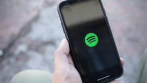 A person holding an iPhone with Spotify for Artists on it.