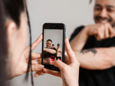 A couple capturing a TikTok video with their cell phone.